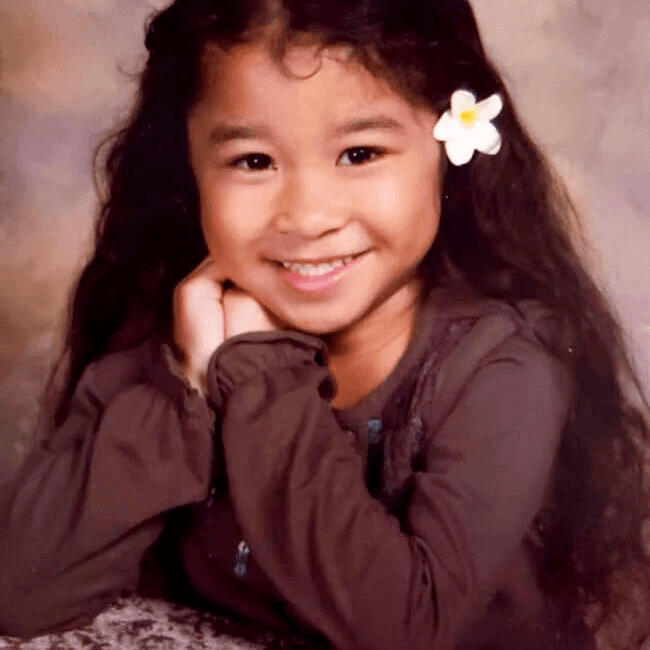 Young Chyler with a plumeria flower in her hair